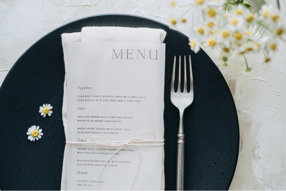 vellum menu design with daisy flowers table styling