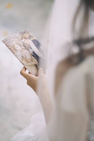 a bride holding a wedding invitation